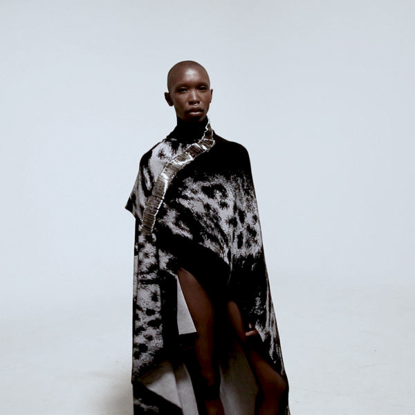 front view model in safety pin cape over white background gif animation