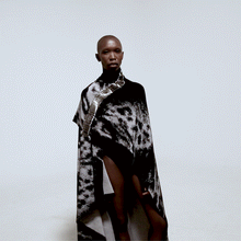 Load image into Gallery viewer, front view model in safety pin cape over white background gif animation