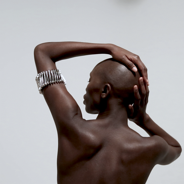 back view model safety pin arm band over white background animated gif