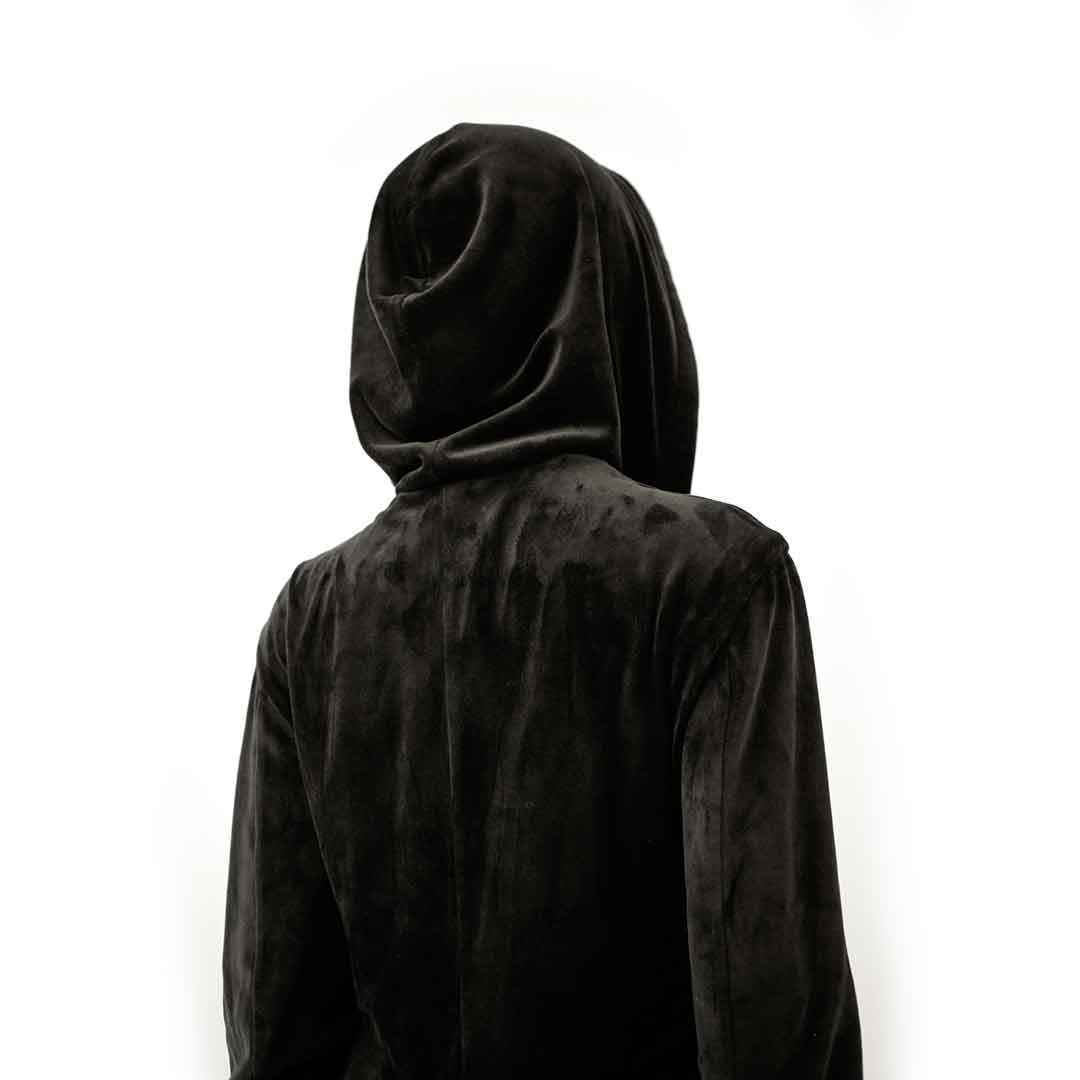 back view of black velvet hoodie coat suit jacket on form over white background