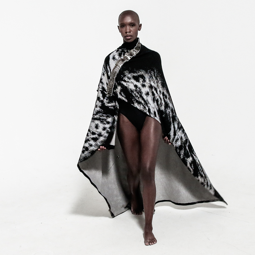 front view model in safety pin cape over white background